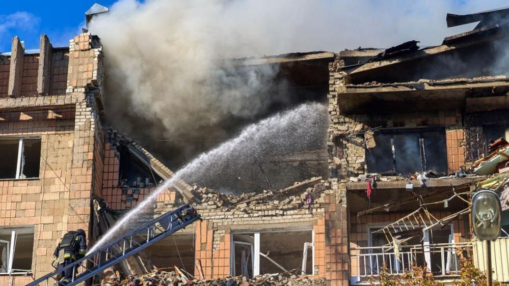 Emergency services responded to a Russian drone strike on a residential building in Kharkiv