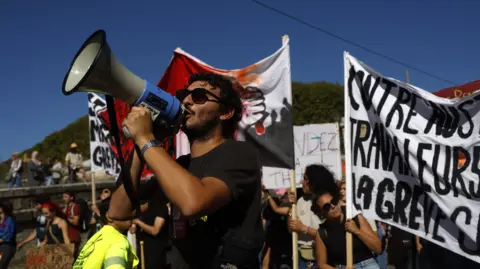 French Workers Unite in Nationwide Strikes Against Budget Cuts