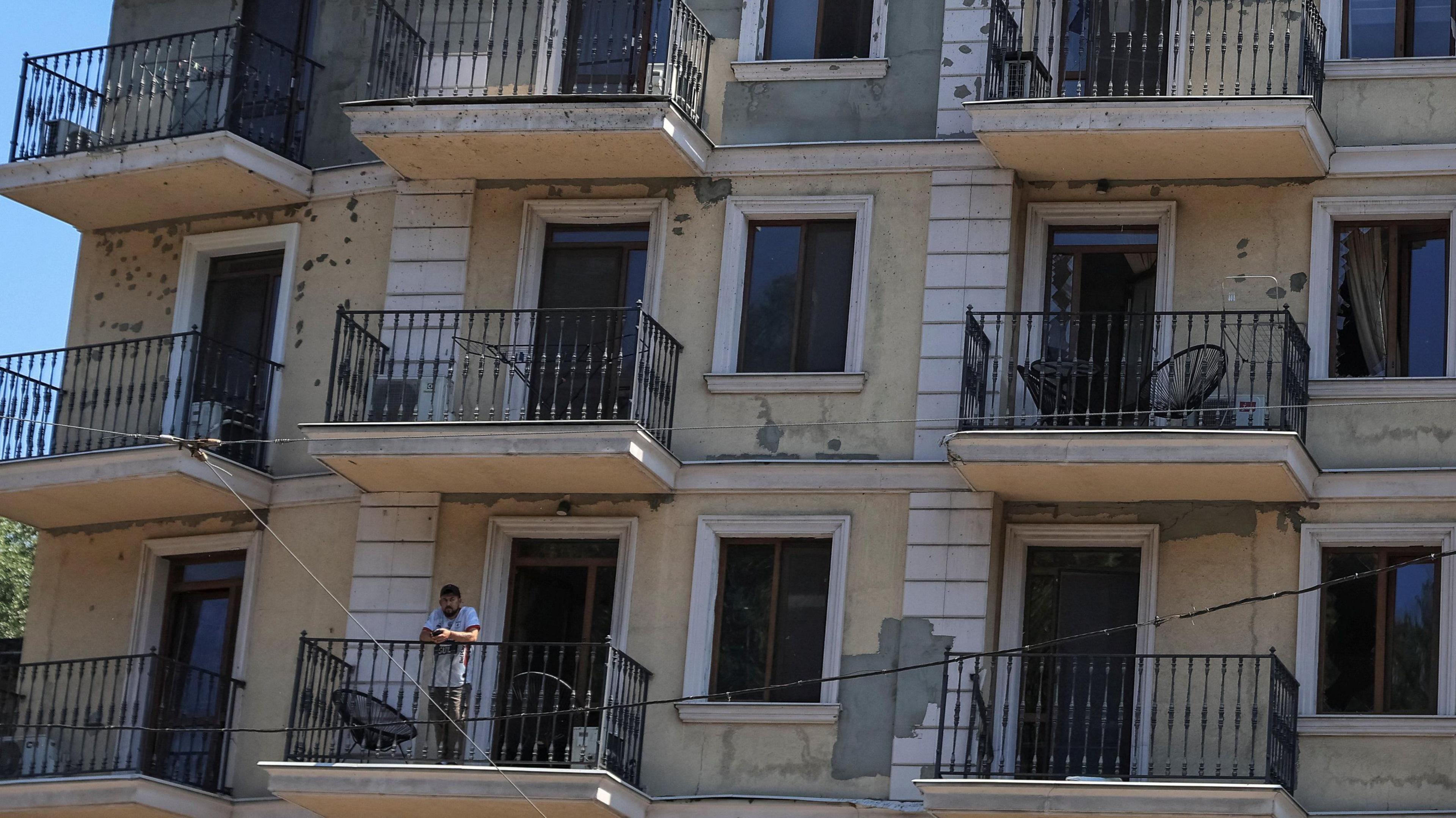 An apartment balcony in Odesa with a resident amid missile strikes