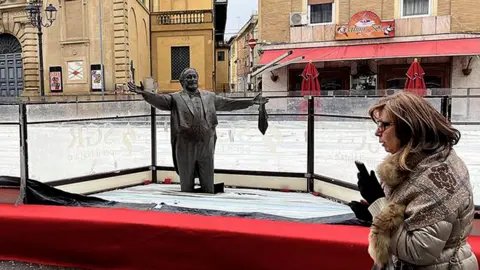 Controversy Erupts Over Pavarotti Statue Encased in Ice Rink in Italy