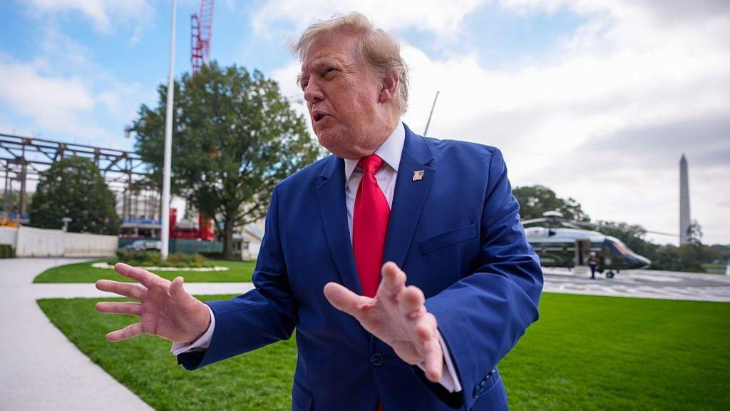 Trump standing and gesturing